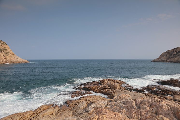 rocky sea coast and blurred water in shek o,hong kong